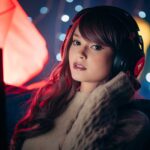woman in knitted sweater wearing a black headphones